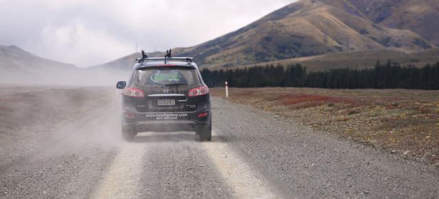 image of car driving on dusty road