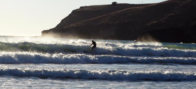 Image of farmer surfing the waves. 