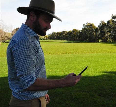 image of farmer using cellphone