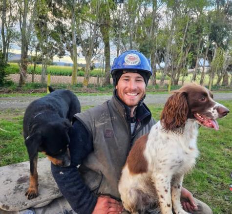 image of Ashley Sim on bike with two dogs either side. 