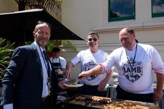 three people eating lamb outside parliament