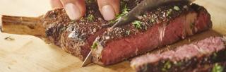 image of person cutting red meat