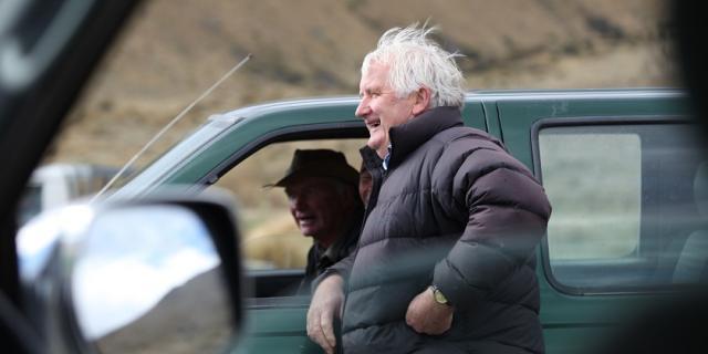 image of two farmers talking outside of ute