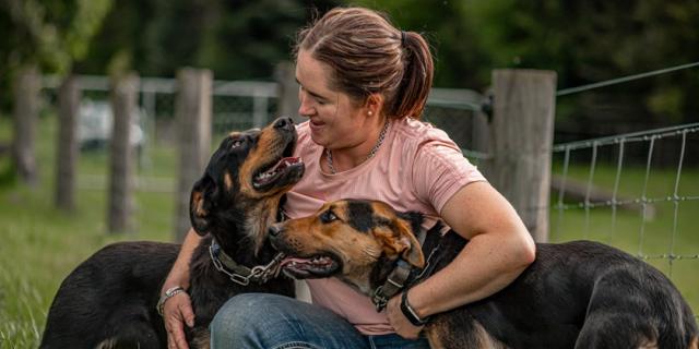 image of Olivia Weatherburn and two farm dogs