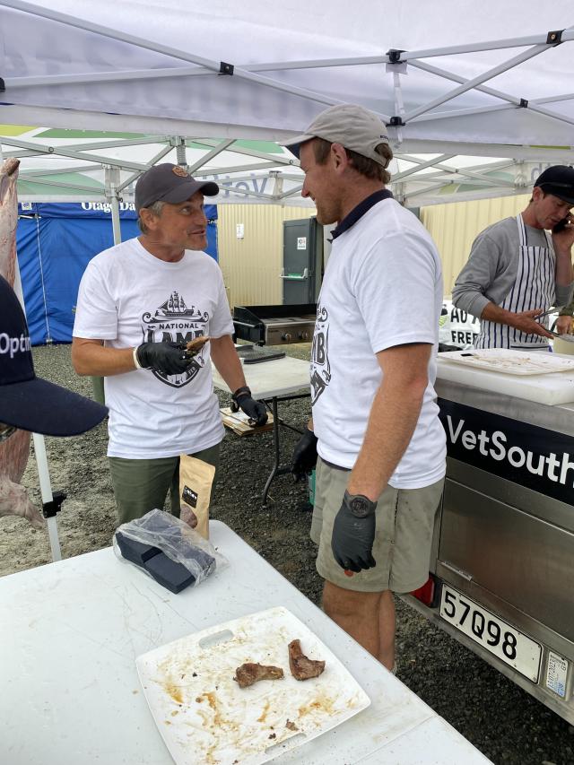 image of two people sampling lamb