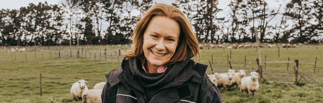 image of Ginny Dodunski on farm with sheep