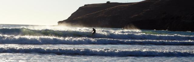 Image of farmer surfing the waves. 